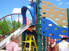 Volunteers construct the playground named the Favre Family Miracle Recreation Area.